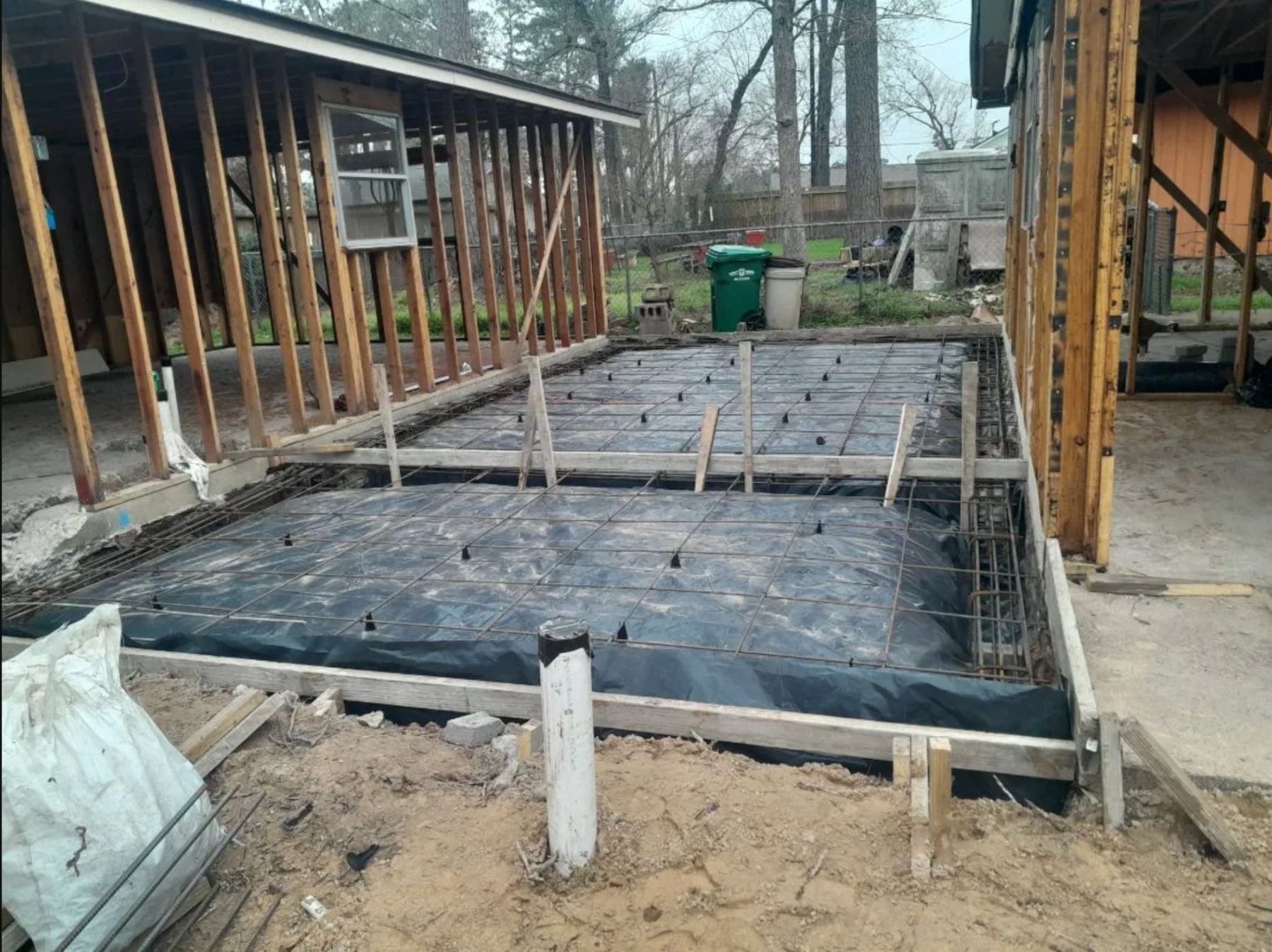 Foundation preparation with concrete footings and moisture barrier for residential construction